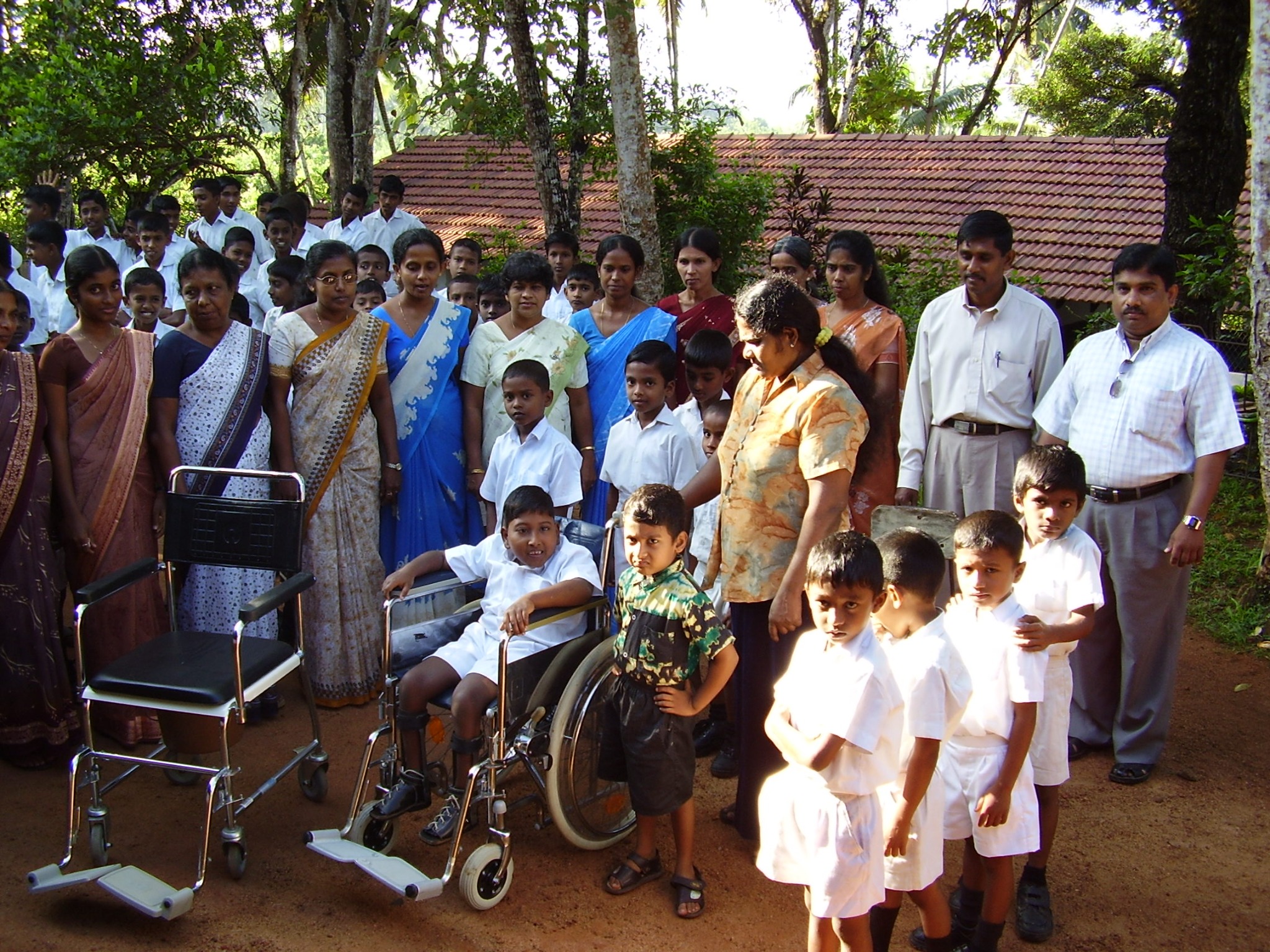 Wheelchair donation with school community members